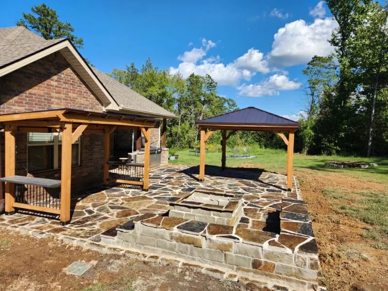 New build front porch with river rock landscaping