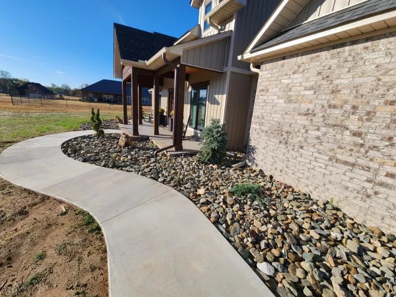 Front yard mulch bed with a Japanese maple and stone border