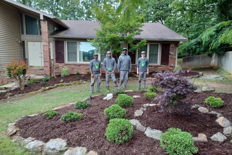 The B & B Lawnscapes crew in front of a finished landscape